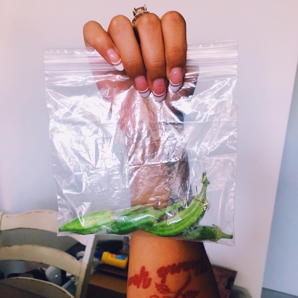 4 okra peppers (??) in a ziploc baggie. held up by a hand with a very cute french manicure (lol).